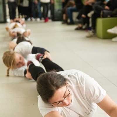 Students are presenting modern dances – they are laying on the floor in the picture