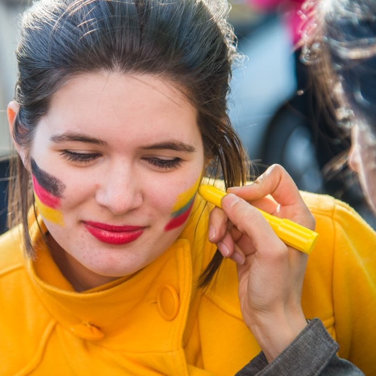 A girl with two flags on her cheeks