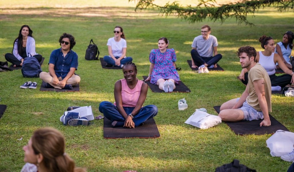 Smiling people sitting on the grass