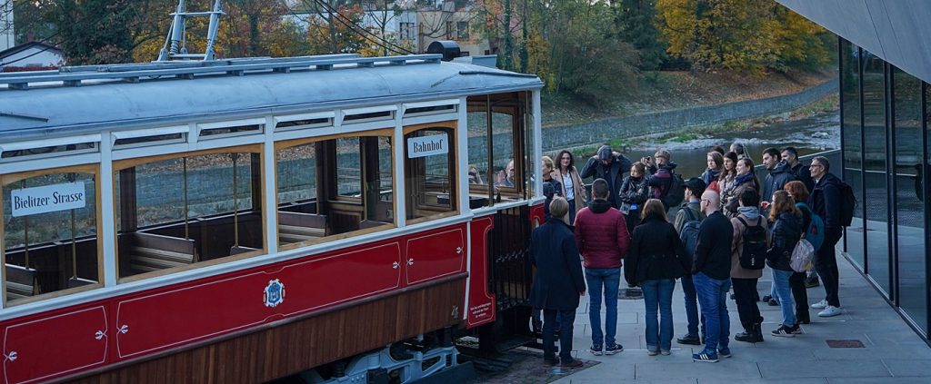 A group of people and a histoirc tram