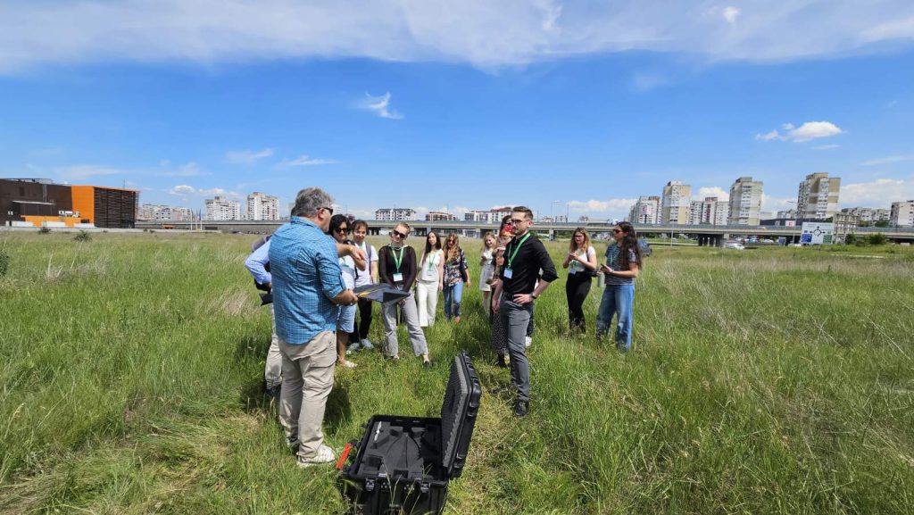 People standing in a field about to launch a drone