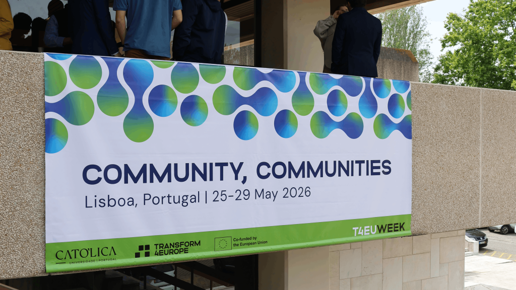 A banner reads “COMMUNITY, COMMUNITIES, Lisboa, Portugal | 25-29 May 2026” with green and blue abstract shapes, and logos for CATOLICA, Transform Europe, and T4EWeek below. People stand behind the banner.