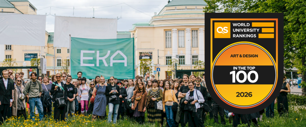 A large group of people stands outdoors in front of a green EKA banner, with historic buildings in the background. Next to them is a badge reading QS World University Rankings Art & Design In the Top 100 2026.