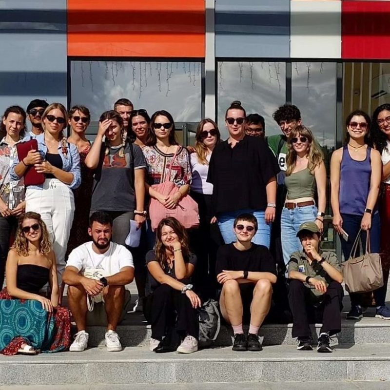 A group of people in front of the building